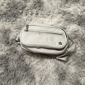 Cloud gray Lululemon belt bag with zipper in front and adjustable